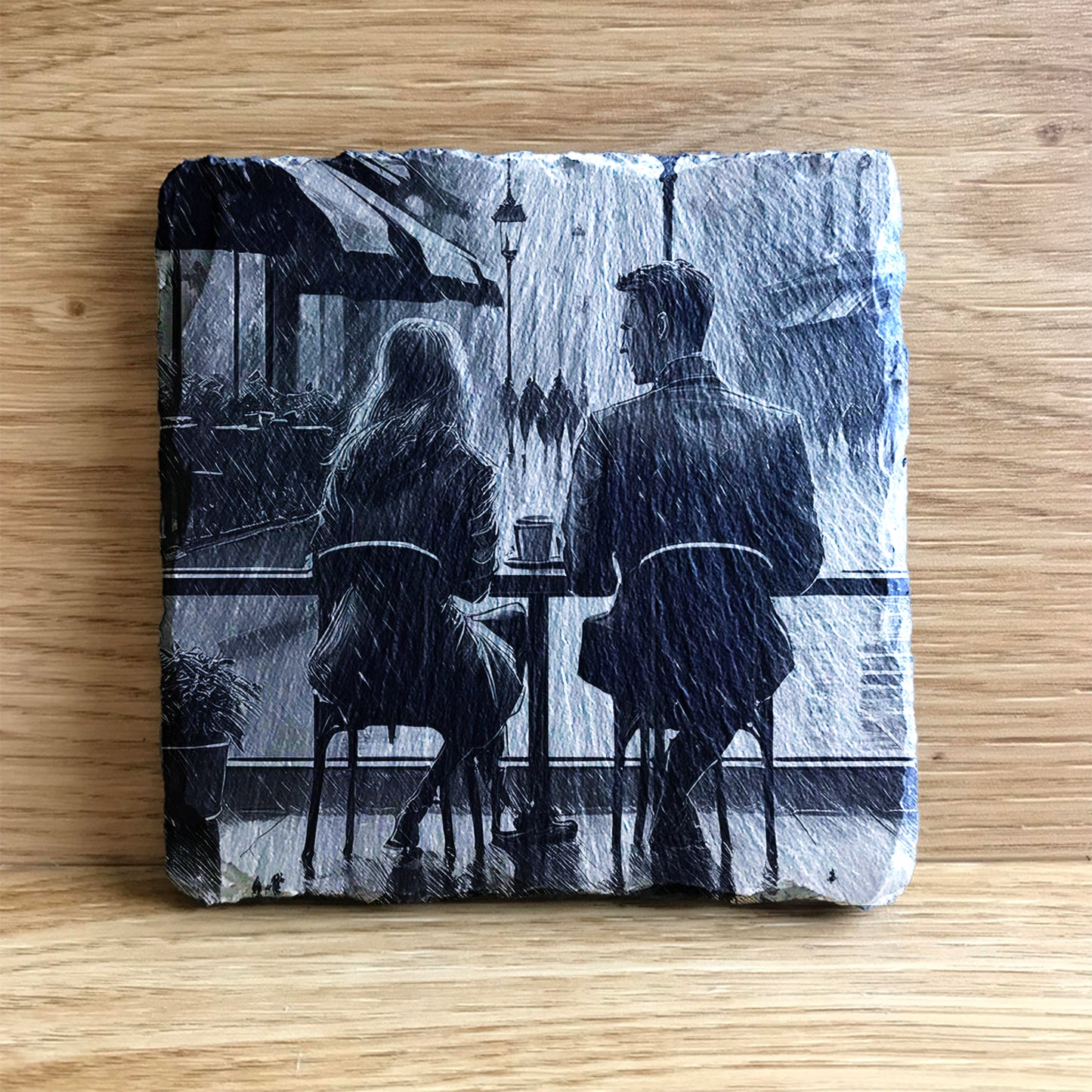 Couple sitting in a cafe looking out at the rain